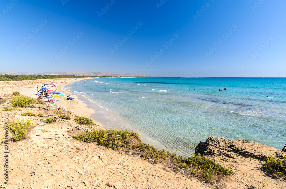 Fototapeta premium Beautiful crystal clear water at Cittadella dei Maccari, San Lorenzo, Nature Reserve Oasis of Vendicari, Syracuse, Sicily, Italy, Dreamy and idyllic spring holiday destination near Noto and Marzamemi.