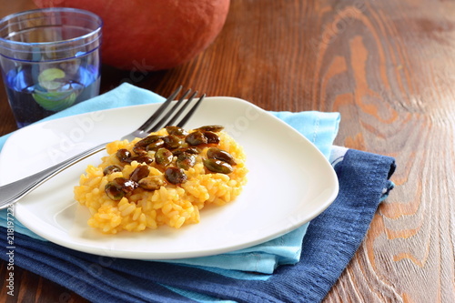 Creamy pumpkin risotto with caramelized pumpkin seeds, copy space