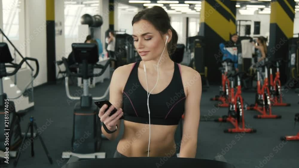 Attractive fit girl jogging in gym Attractive fit girl jogging in gym