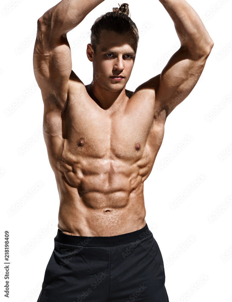 Foto Stock Sporty man showing off his muscular physique and six pack abs.  Photo of young man with perfect body after training on white background.  Strength and motivation | Adobe Stock