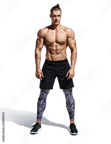 Muscular man. Photo of handsome man with perfect physique after training isolated on white background. Strength and motivation. Full length