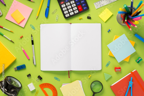 notebook and school accessories at abstract background
