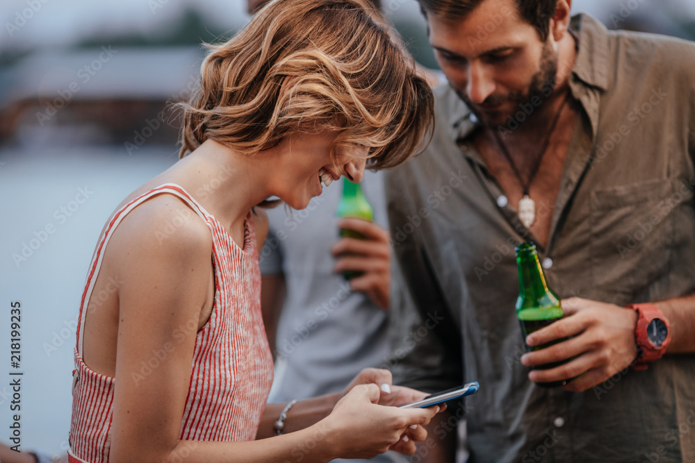 Woman Holding Cell Phone and Talking at Party Woman Holding Cell Phone and Talking at Party