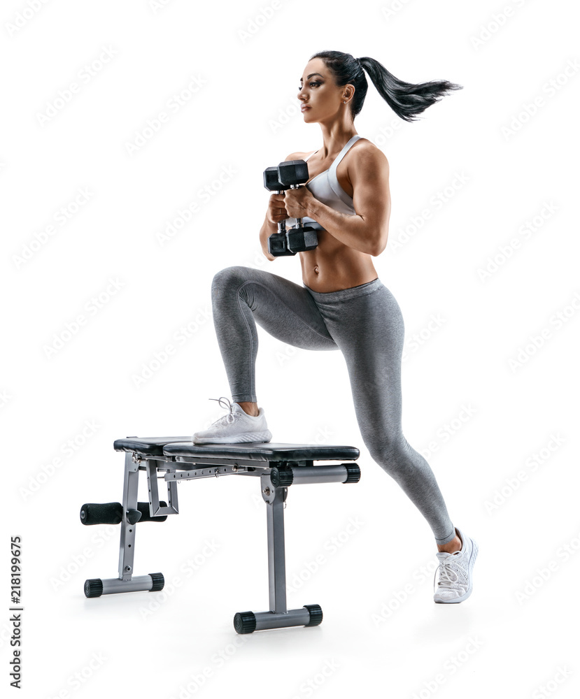 Fitness woman doing jump step ups exercise with dumbbells on bench