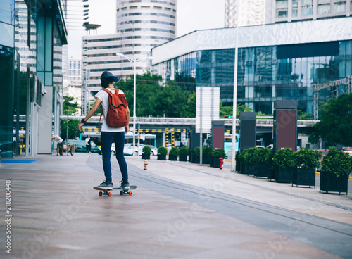 Woman skateboarder riding skateboard on city street