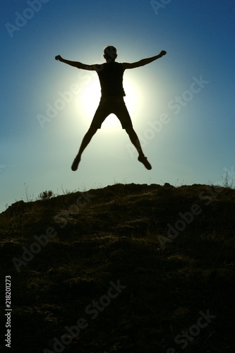 Man Jumping Against Sun