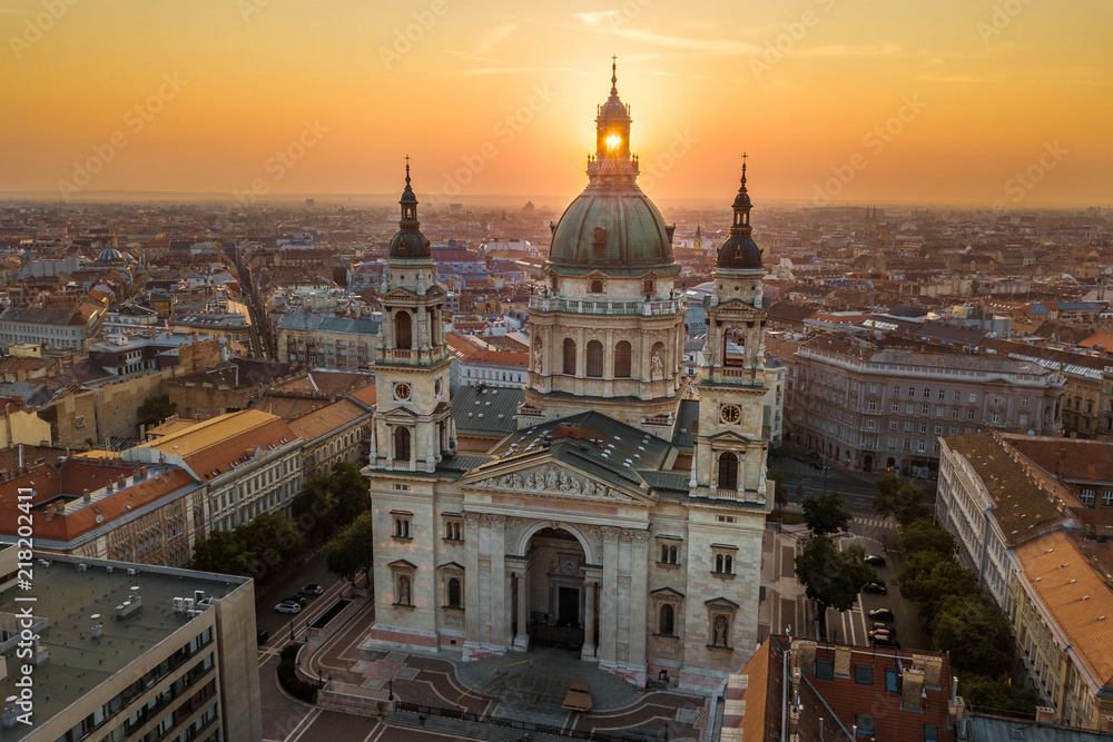 Budapest, Hungary - The rising sun shining through the tower of the beautiful St.Stephen's Basilica (Szent Istvan Bazilika) at sunrise on an aerial shot