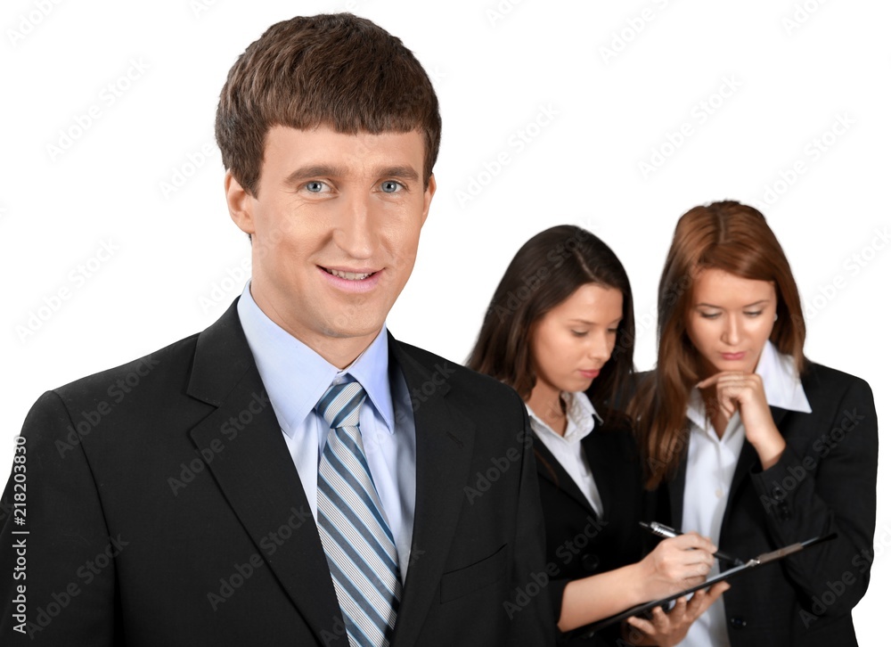 Friendly Businessman and Talking Collaborators in Background - Friendly Businessman and Talking Collaborators in Background -