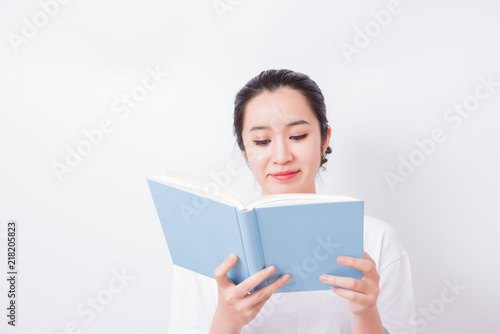 Young woman reading book. Isolated on white background.