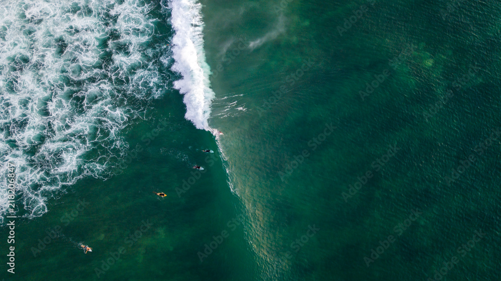 Aerial: Surfers catching the ocean waves