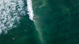 Aerial: Surfers catching the ocean waves