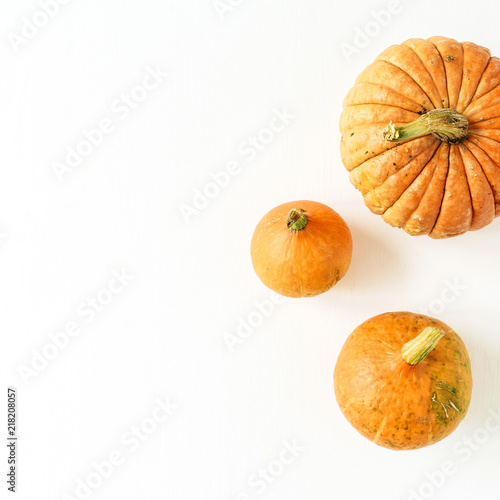 Pumpkins on white background. Fall autumn halloween concept. Flat lay, top view.