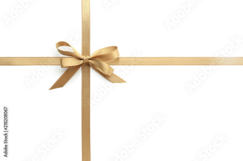 Golden ribbons with bow on white background photo