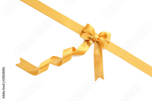 Golden ribbon with bow on white background