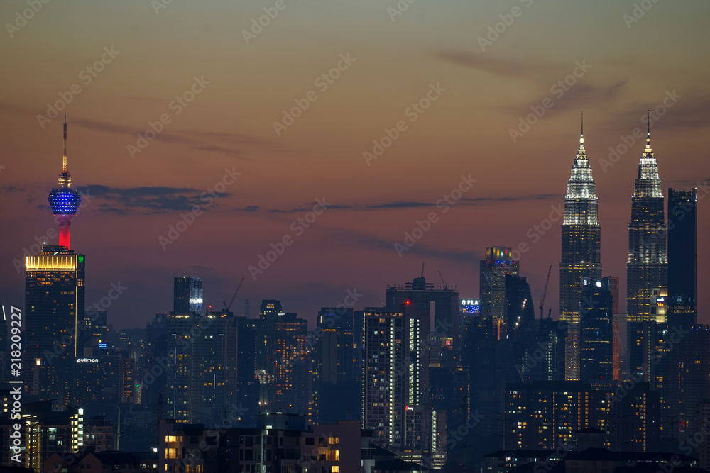 Majestic sunset over Twin Towers and surrounded buildings in downtown Kuala Lumpur, Malaysia.	