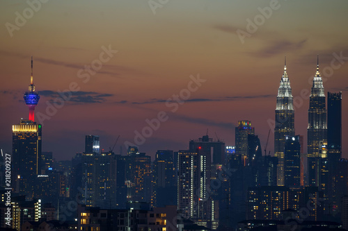 Photography Majestic sunset over Twin Towers and surrounded buildings in downtown Kuala Lumpur, Malaysia