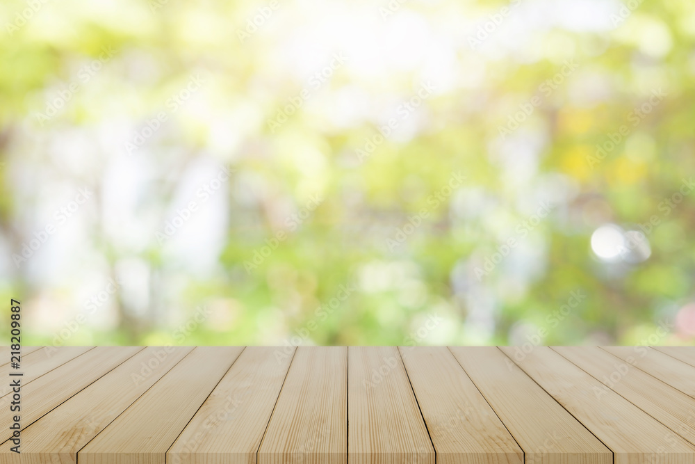 Empty wooden desk of free space and spring time with blurred background of home garden for a catering or food background,Template mock up for display montages of product.