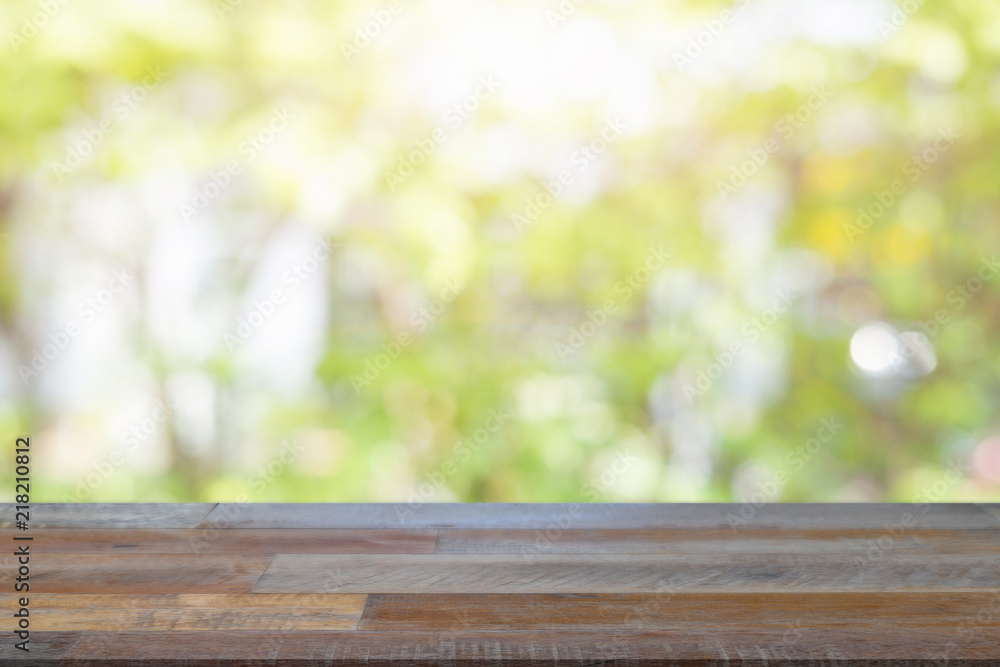 Empty wooden desk of free space and spring time with blurred background of home garden for a catering or food background,Template mock up for display montages of product. Empty wooden desk of free space and spring time with blurred background of home garden for a catering or food background,Template mock up for display montages of product.