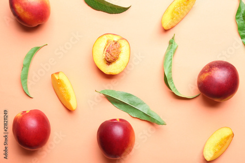 Composition with ripe peaches on color background, top view