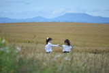 Two girls playing in the wheat field