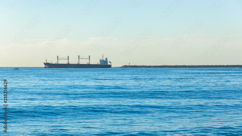 Ship Departs Harbor Piers onto ocean seas landscape