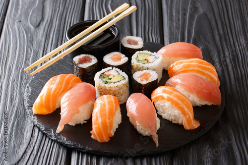 Japanese sushi on a rustic dark background. Sushi rolls, nigiri, maki, soy sauce. Sushi set on a table. background. Asian food. Horizontal