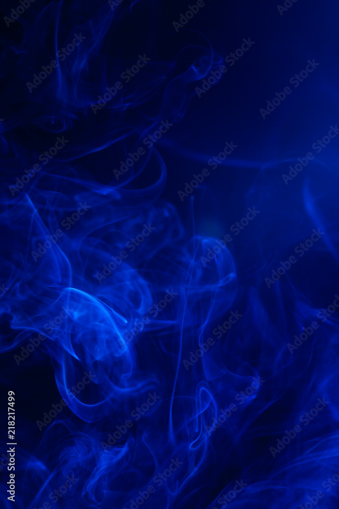 Fototapeta premium Blue smoke on black background.