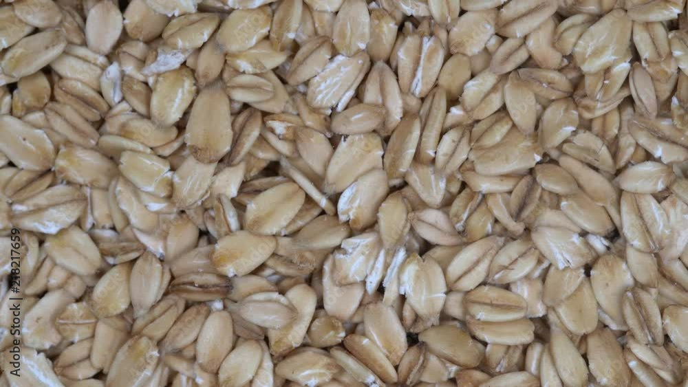 Dry oat flakes grains background, close up rotation loopable 4k top view. Food background. Gastronomy concept, organic food. Macro rotation oat flakes Dry oat flakes grains background, close up rotation loopable 4k top view. Food background. Gastronomy concept, organic food. Macro rotation oat flakes