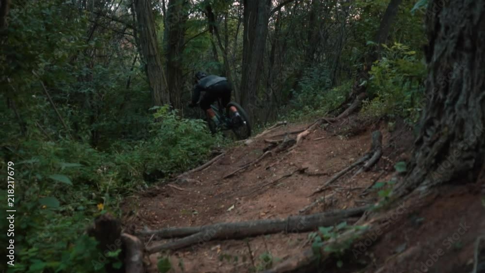 extreme bicyclist rides on forest path, slow motion extreme bicyclist rides on forest path, slow motion