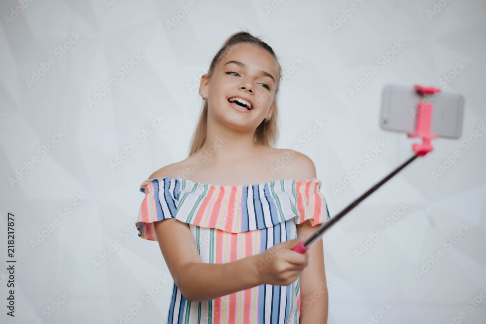 Beautiful young girl is making selfie photo with smartphone. Young hipster woman making selfie. Photo.Smartphone Beautiful young girl is making selfie photo with smartphone. Young hipster woman making selfie. Photo.Smartphone