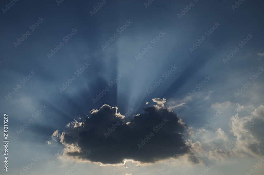 The blue sky, the white clouds, and the bright light of the sun