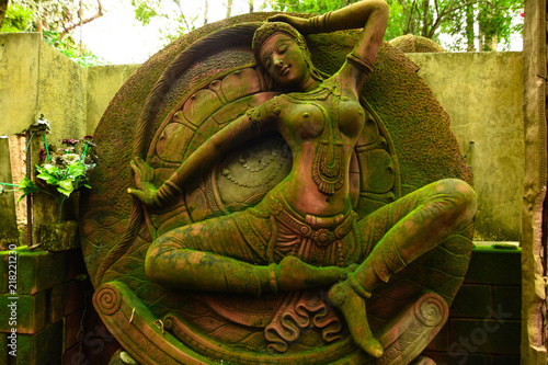 Statue of Goddess naked chest There are green moss on the body. 	