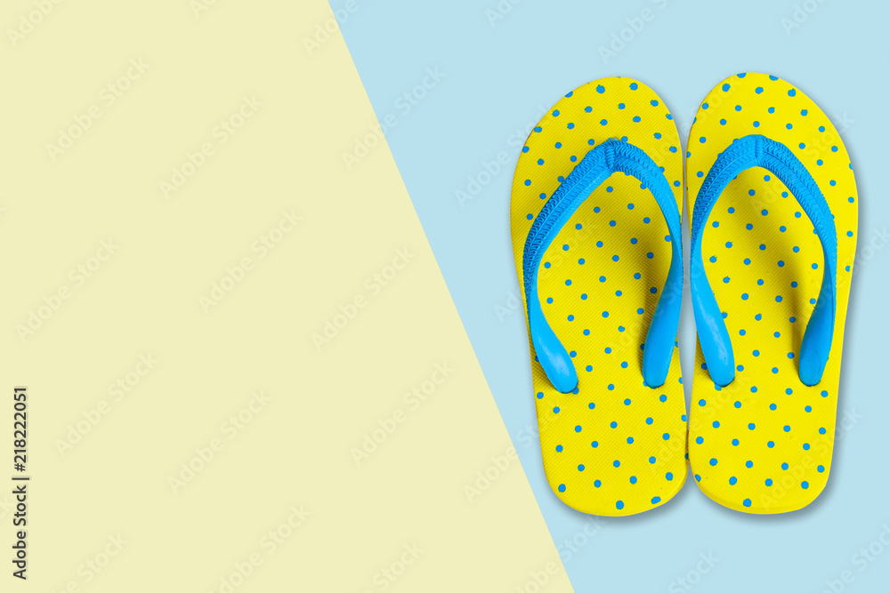 Yellow sandals on pink and blue color background, flat lay photo Yellow sandals on pink and blue color background, flat lay photo