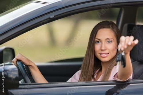 Portrait of a Smiling Woman Looking out of the Window of her Car