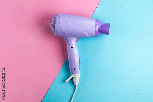 Hairdryer on a bright, colored background. Hairdressing Supplies. Beauty saloon. Fashion concept. Top view