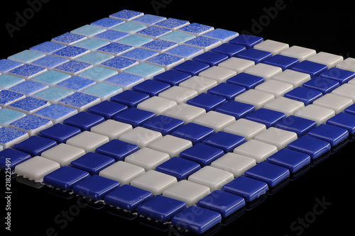 little blue ceramic tile on a black background, majolica. for the catalog