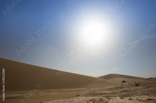 Tourists ride Camel over Sunshine Summer Desert