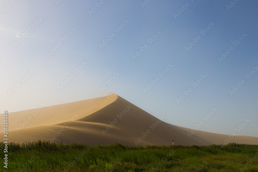 Empty Desert in Sand storm over blue sky summer