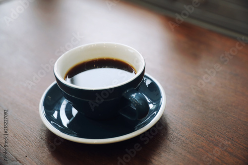 Black coffee in Coffee cup on wood background