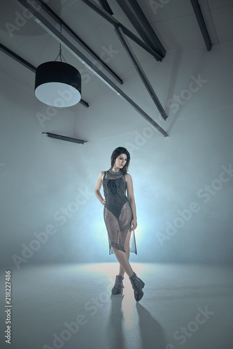 Fashionable woman posing with illumination from behind