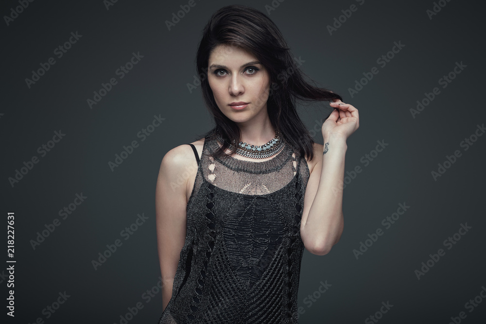 Portrait brunette attractive woman touching her hair Portrait brunette attractive woman touching her hair