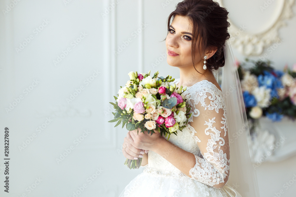 Beautiful bride with fashion wedding hairstyle - on white background Wedding. Studio shoot.Beautiful bride with bouquet of flowers Beautiful bride with fashion wedding hairstyle - on white background Wedding. Studio shoot.Beautiful bride with bouquet of flowers