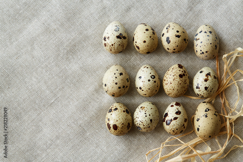 Flatview of quail eggs on linen fablic background