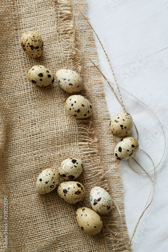 Flatview of some quail eggs on sacloth background