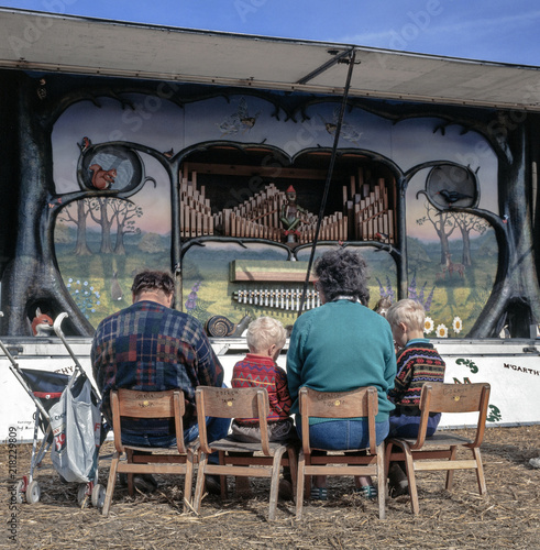 Family  listening to organ music at Steamfair Dorset England photo