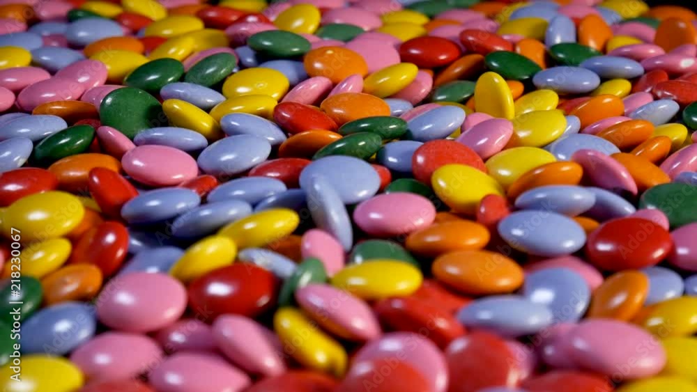 Sweet Chocolate candy in different color rotating in close up Sweet Chocolate candy in different color rotating in close up