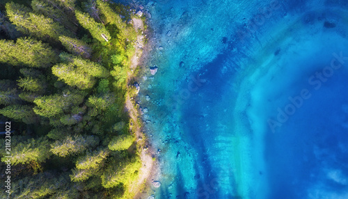 Aerial view on the lake and forest. Natural landscape from drone. Aerial landscape from air in the Dolomite alps, Italy. photo