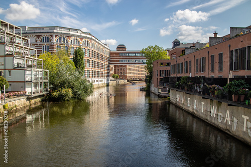 Picture from the river elster in leipzig .It is a popular place of residens in modern architectur in old buildings with name  buntgarnwerke .This is a beautiful place for watersports.