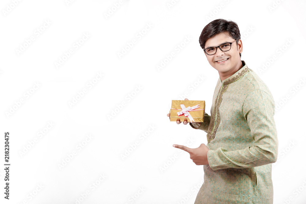 young Indian on traditional wear showing gift young Indian on traditional wear showing gift