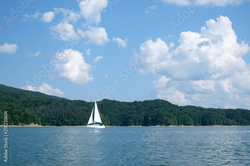 White yacht on Solina lake, Poland. Landscape photography